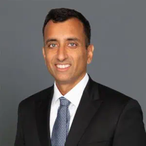 Headshot of Amit Chokshi, M.D. in professional wear with a grey background.