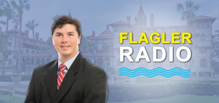 Dr. Koike smiles in front of an image of Flagler College. Flagler Radio logo is featured to the right of him