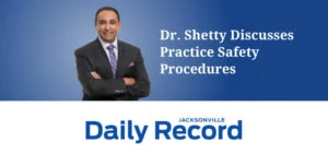 Dr. Rajesh Shetty standing in front of a blue background with his arms crossed. The image reads "Dr. Shetty Discusses Practice Safety Procedures" and includes the Jacksonville Daily Record logo.