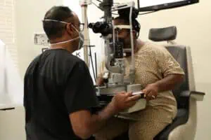 Dr. Shetty inspects Marian Rogers eyes during an eye exam