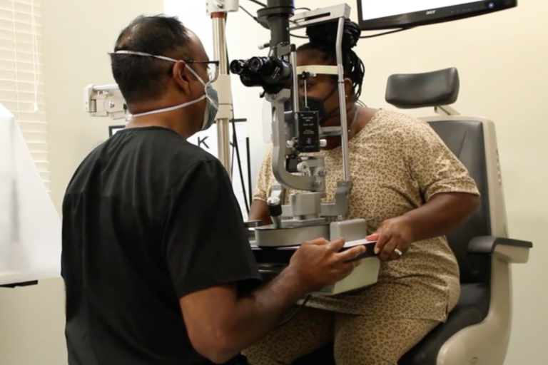 Dr. Shetty inspects Marian Rogers eyes during an eye exam