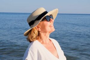 A woman with sunglasses at the beach