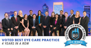 FES team poses against a Jacksonville skyline background. Text on image reads "Voted Best Eye Care Practice 4 Years in a Row"