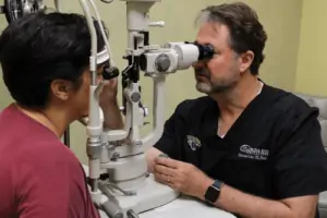 Dr. Christian Guier performs an eye exam on a patient