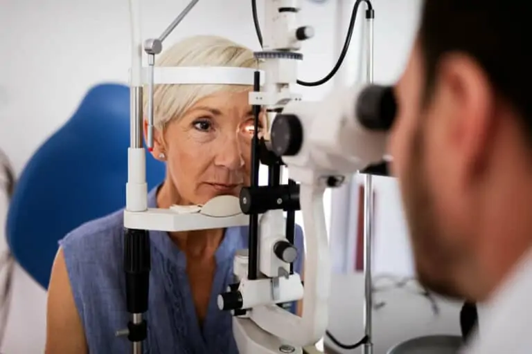 Doctor looks into a patients eye using a tool