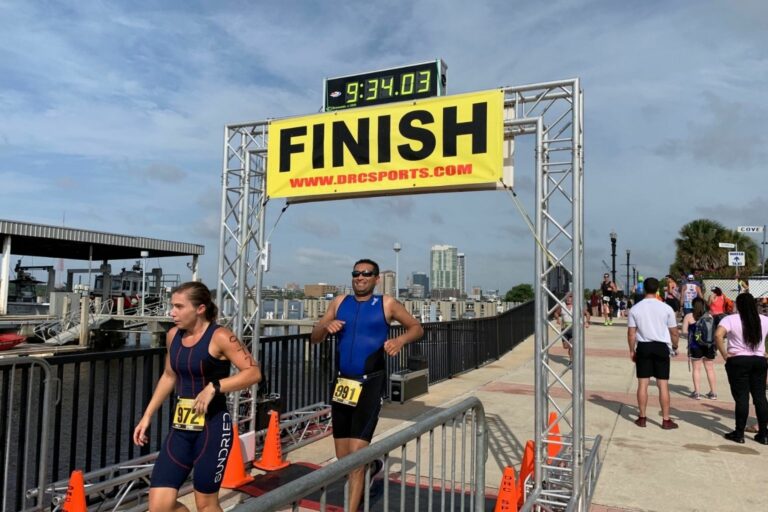 Dr. Ravi Patel runs underneath a race finish line