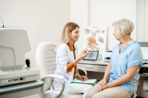 Senior woman patient talking with female ophthalmologist during a medical consultation at the ophthalmologic office