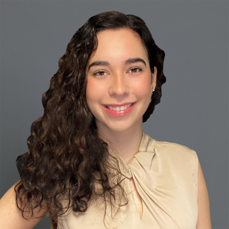 Headshot of Karen Muñoz in professional wear with a grey background.