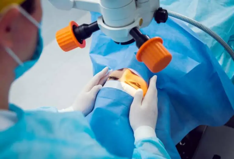 Surgeon observes patient on surgical table