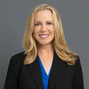Headshot of Dr. Kellough in professional wear with a grey background.