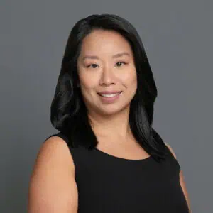 Headshot of Dr. Lawing in professional wear with a grey background.
