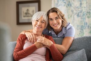 A senior woman and middle-aged woman hug