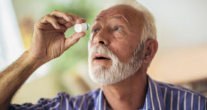 Elderly Person Using Eye Drops At Home