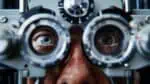A man is undergoing an eye examination by an ophthalmologist to ensure his vision is safe for driving. He may need eyewear for Automotive lighting and Personal protective equipment for driving safety